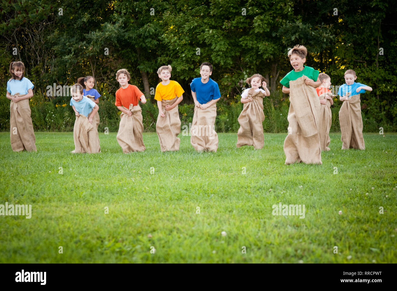 Happy Kids Having Potato Sack Race Outside Stock Photo Alamy