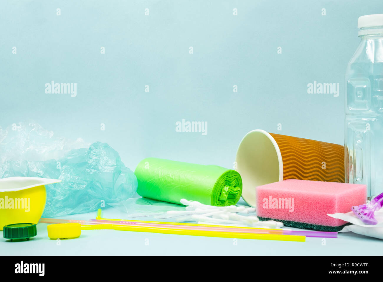 Plastic waste concept: varitety of single use objects that get thrown out every day. Plastic bottle, hygiene items and plastic package depicting ecolo Stock Photo