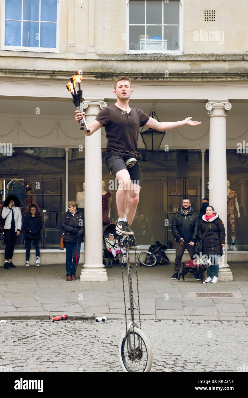 A Street Entertainer in Stall St Bath. Fire juggling on a mono cycle, naturally.. Stock Photo