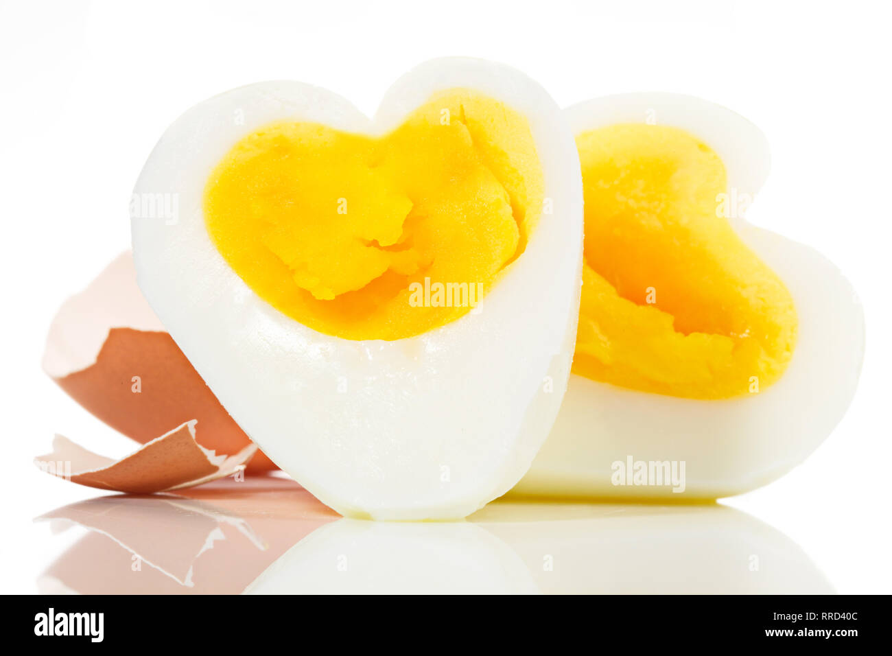 Soft boiled Egg in Heart Shape on white Backround Stock Photo