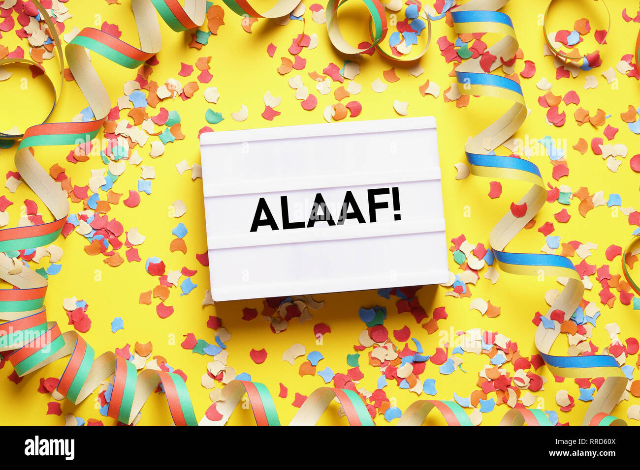 Alaaf is the traditional german fool's call used during carnival in Cologne - flat lay with confetti and streamers Stock Photo