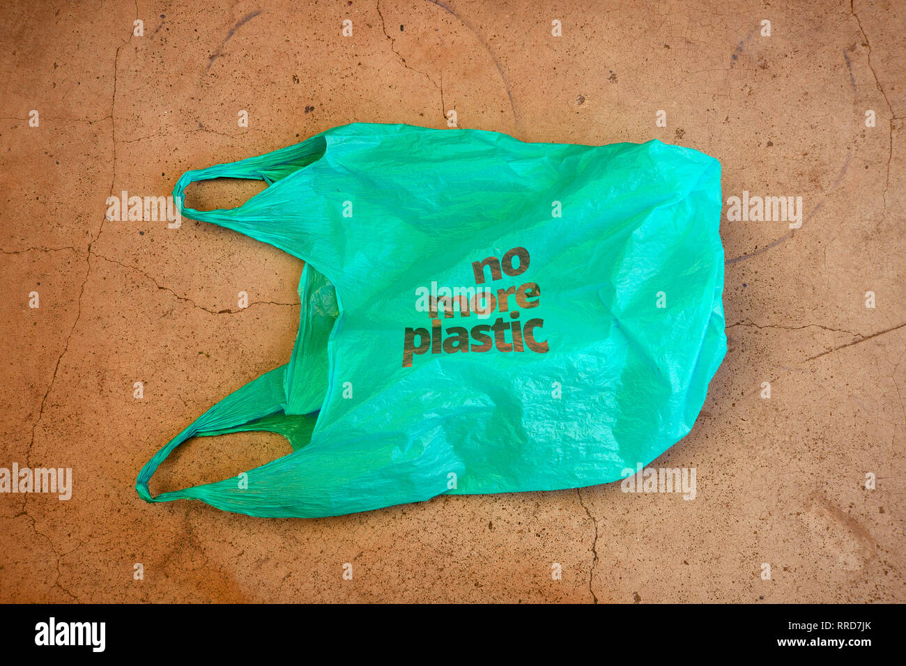No plastic. Environmental awareness care vindication shot. It shows a green plastic bag with motto no more plastic. Stock Photo
