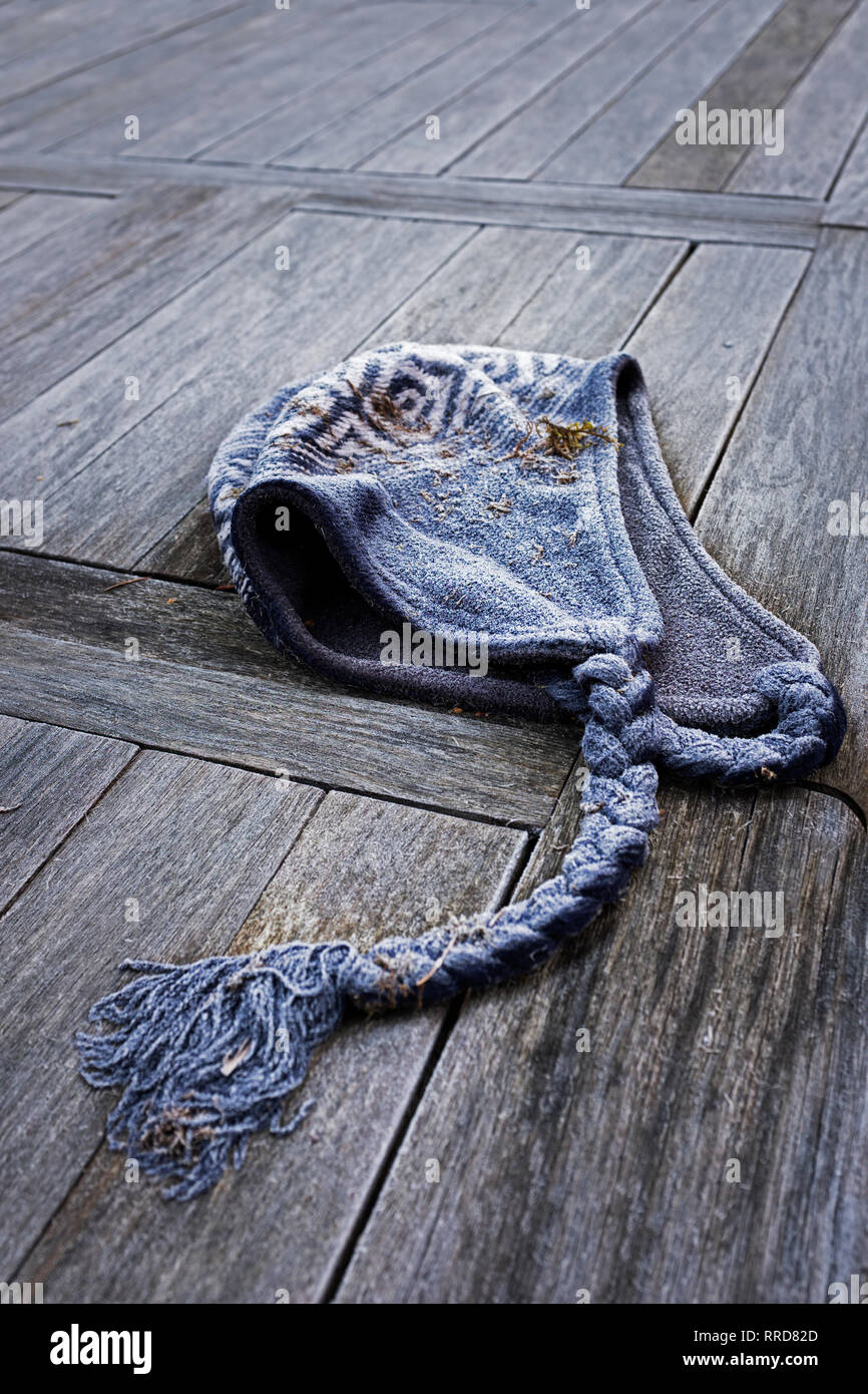 Discarded woolly hat covered with frost. Stock Photo