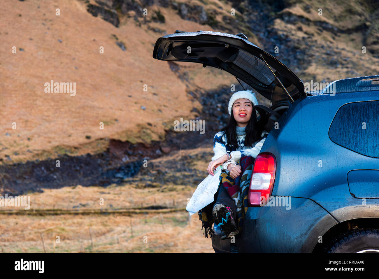 Female traveler enjoying Iceland view from the car trunk Stock Photo