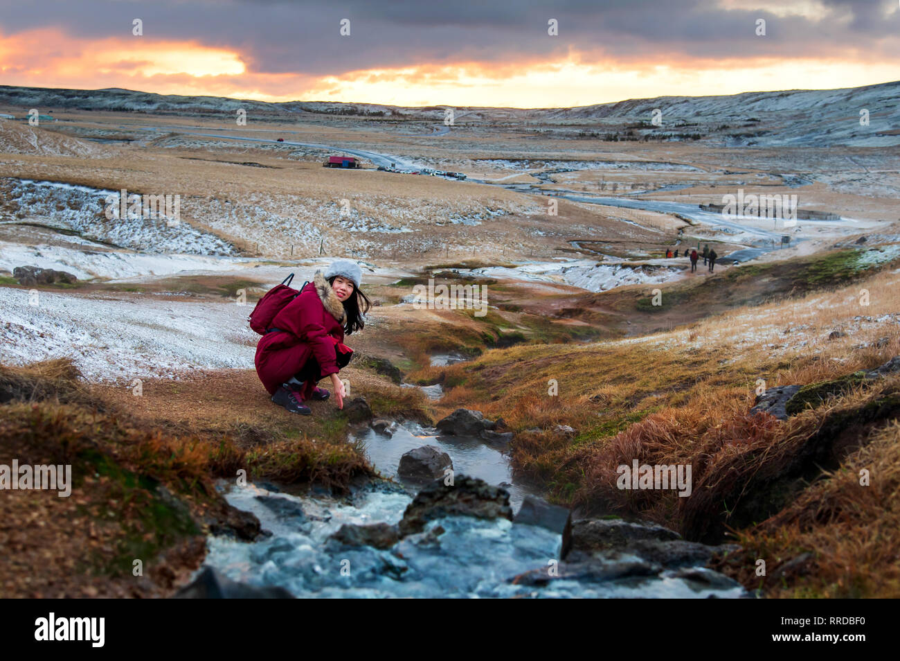 Female traveler by a thermal river in Reykjadalur, Iceland Stock Photo