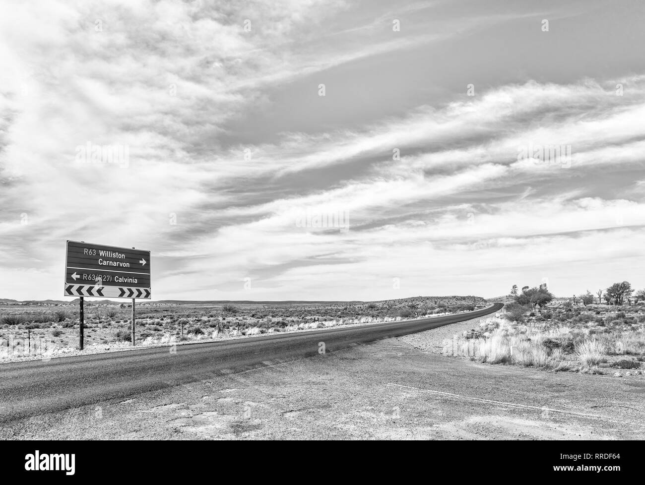 A directional road sign on road R63 near Williston in the Northern Cape Province of South Africa. Monochrome Stock Photo