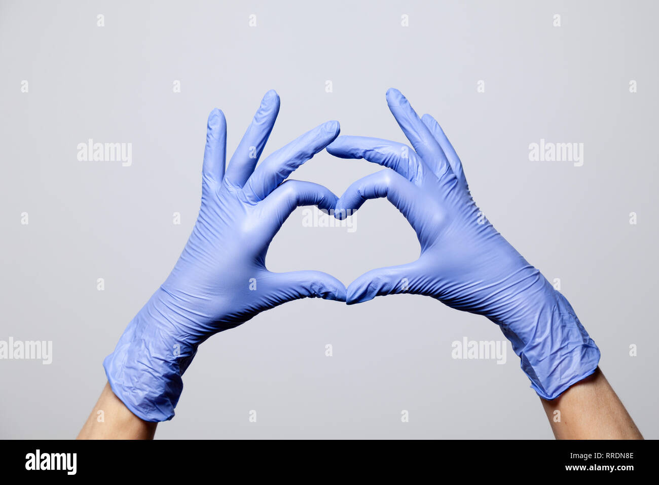 Closeup of a hand in latex rubber medical purple gloves folded