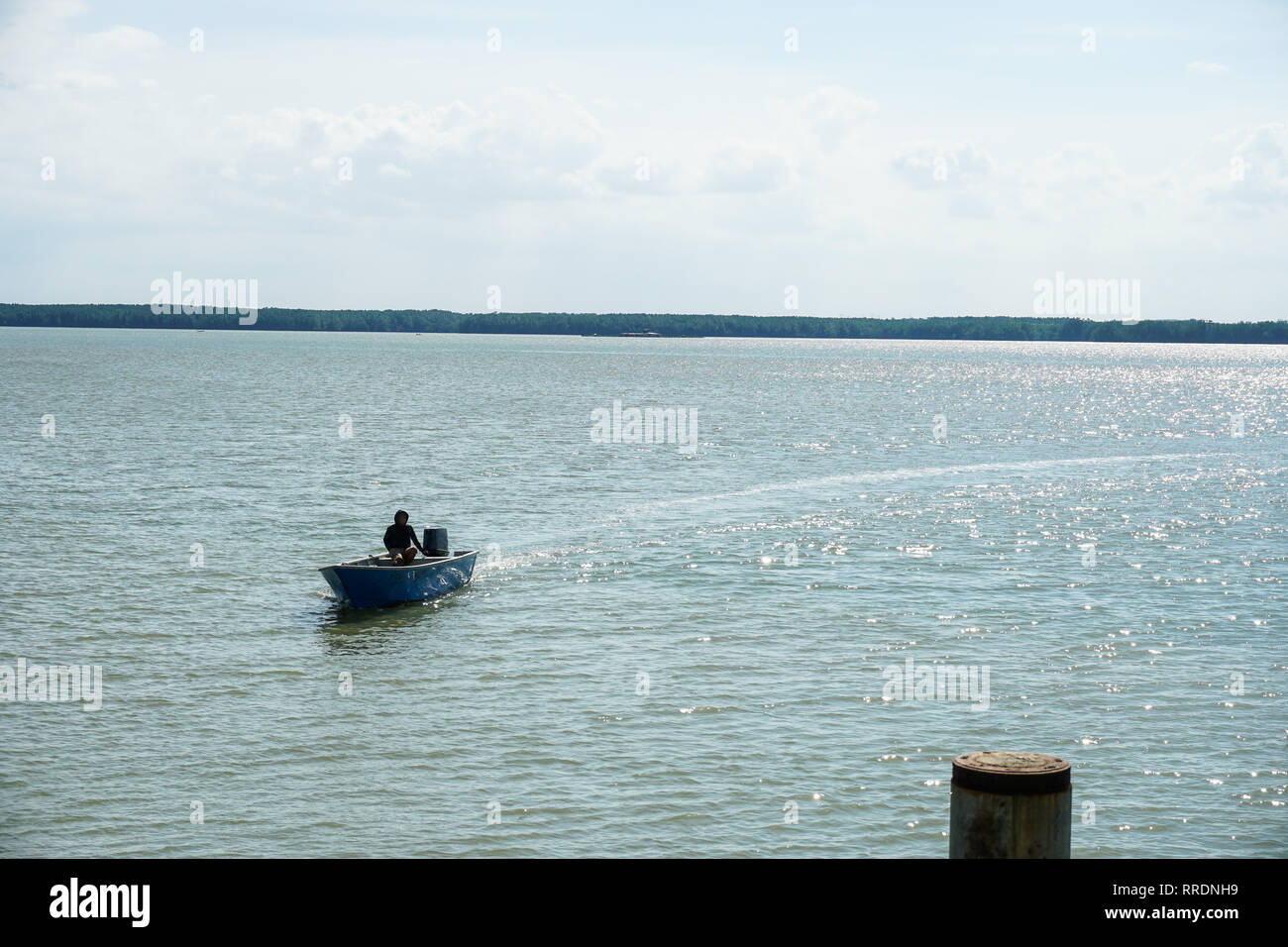 Man steering boat through scenic hi-res stock photography and images ...