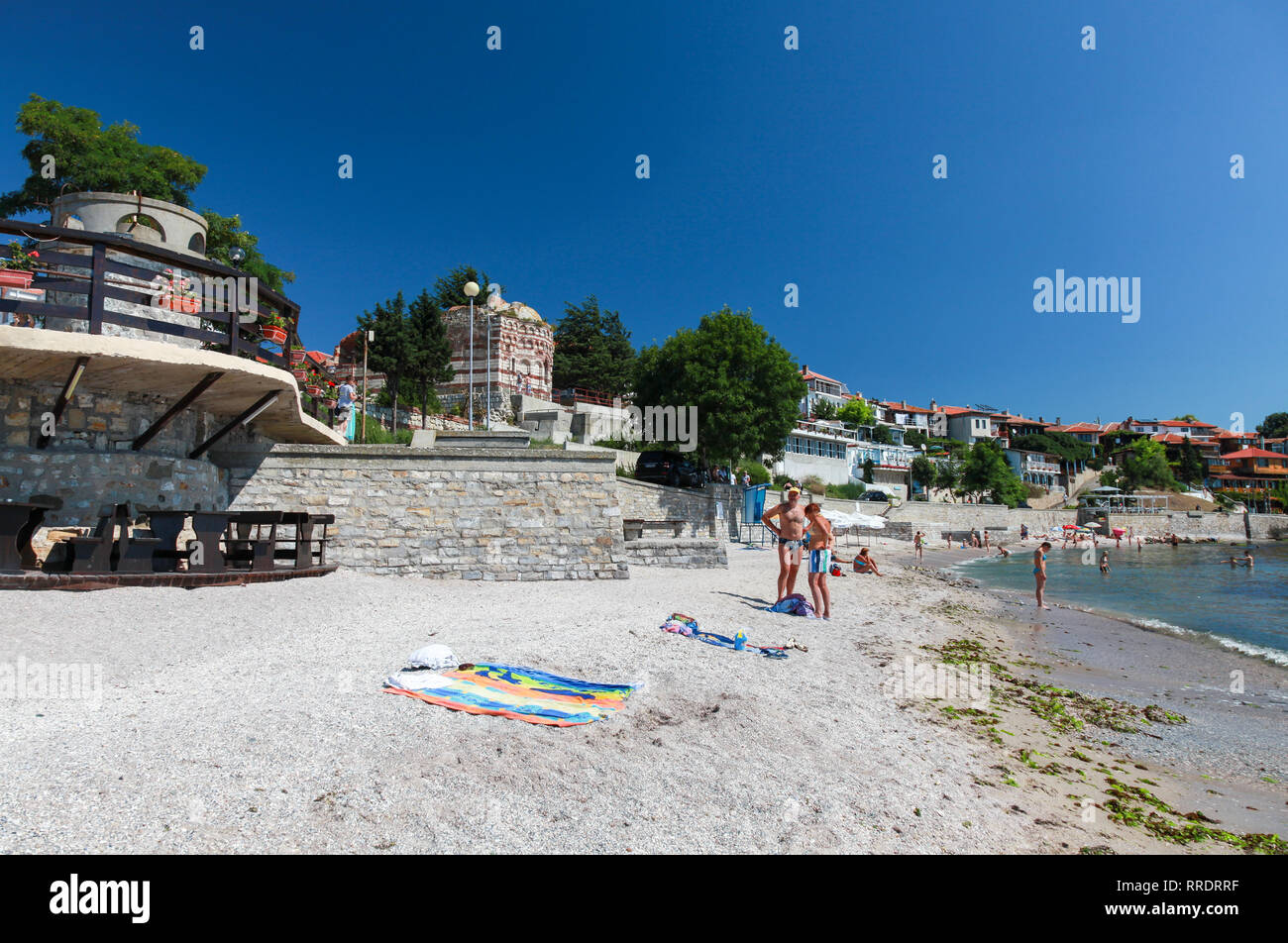 Nesebar, Bulgaria - July 21, 2014: Tourists relax on the public beach in old town Nesebar, Black Sea coast Stock Photo