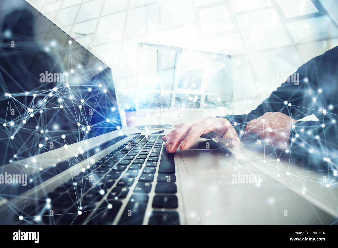 Business man works in office with laptop in the foreground. Concept of teamwork and partnership. double exposure with network effects Stock Photo