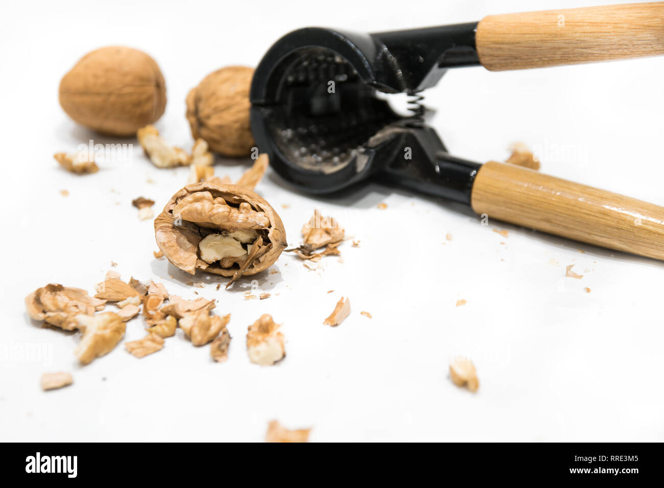 Nutcracker, walnut kernel peeled and whole nutshells, isolated on a white background. Dried fruit Stock Photo