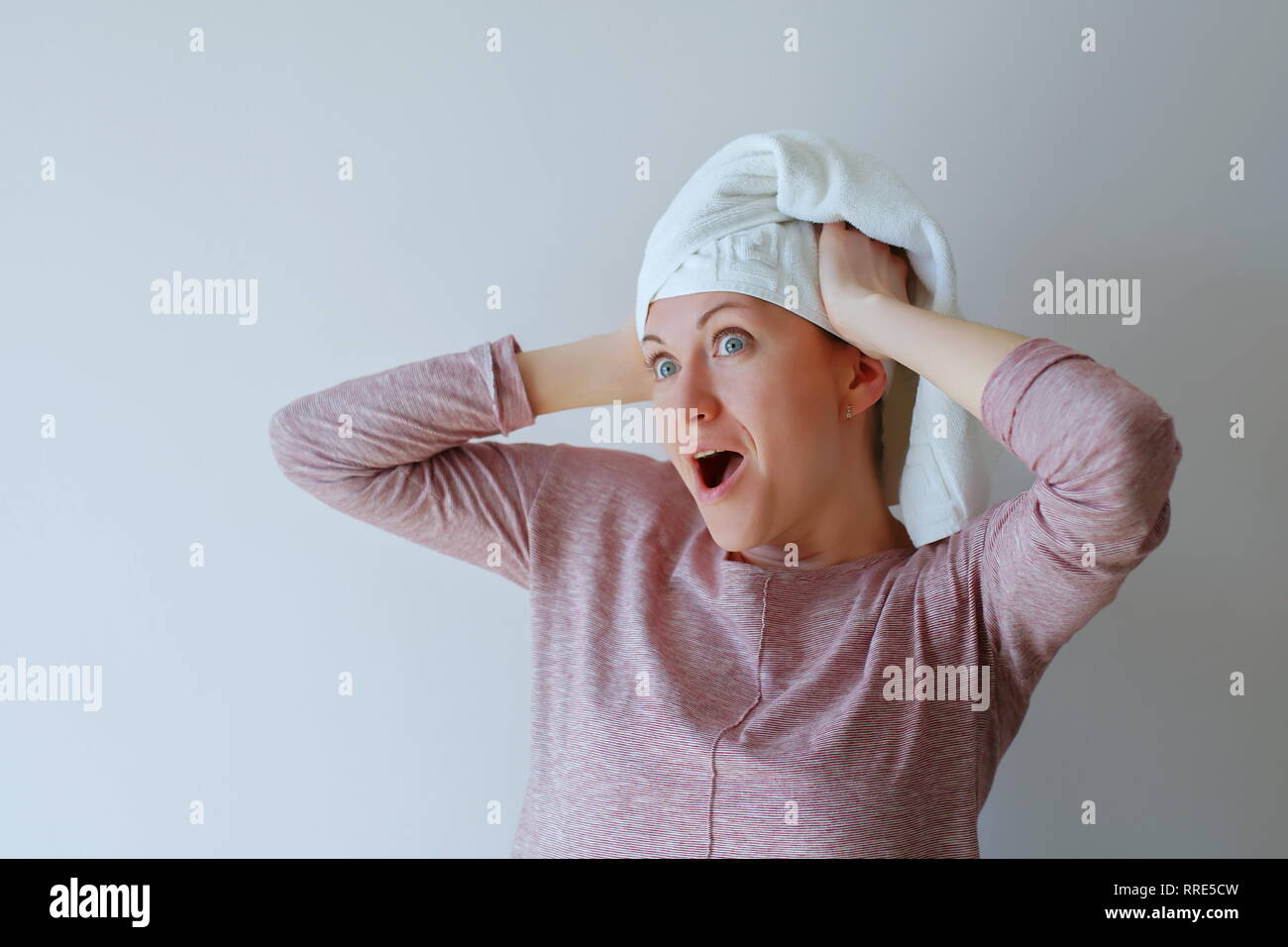 Portrait of a surprised woman. Stand still you gonna be shocked. Portrait of surprised and excited speechless girl with hands on the face Stock Photo