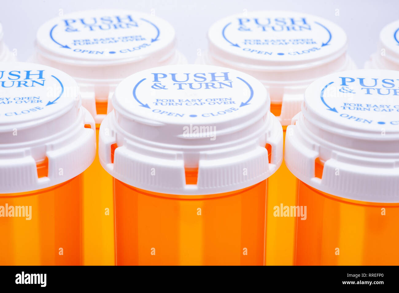 https://c8.alamy.com/comp/RREFP0/orange-plastic-empty-prescription-containers-with-child-resistant-pushturn-cap-RREFP0.jpg