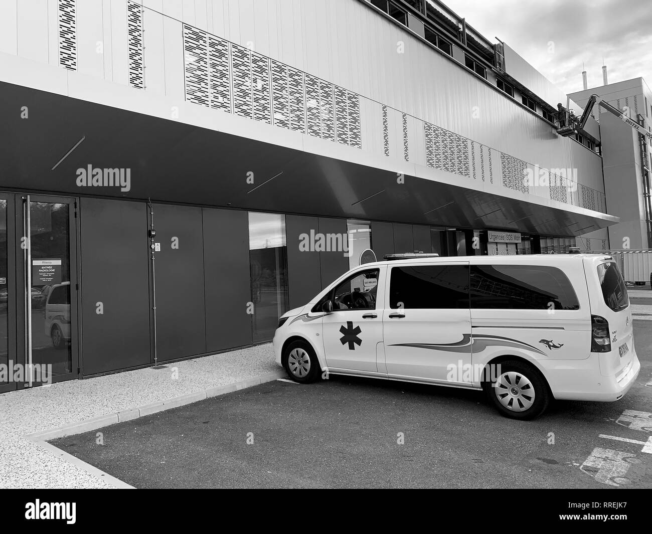 STRASBOURG, FRANCE - OCT 2, 2018: White ambulance van parked in front of hospital Rhena - the new hospital in Strasbourg - black and white Stock Photo