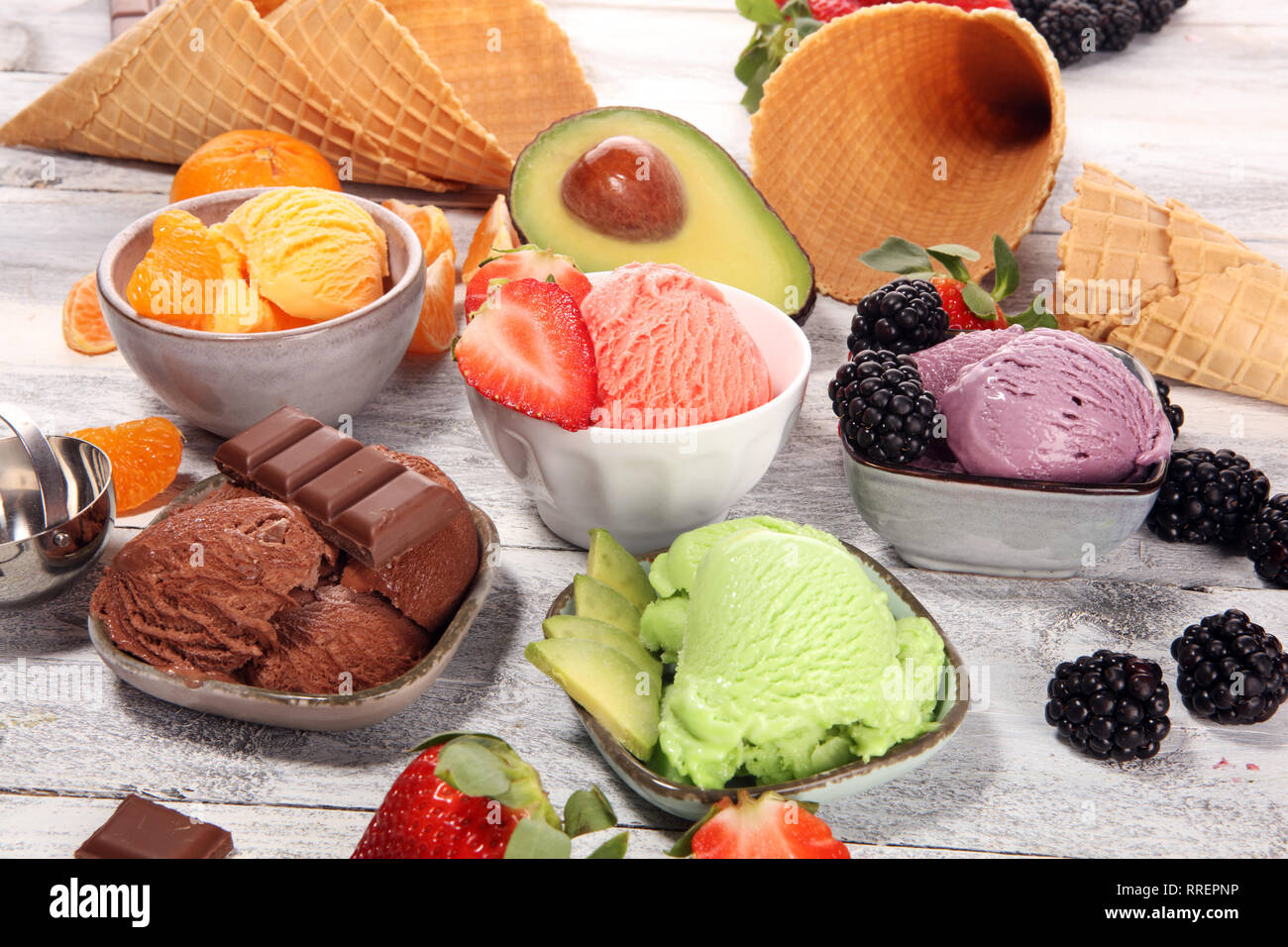 Set of ice cream scoops of different colors and flavours with berries