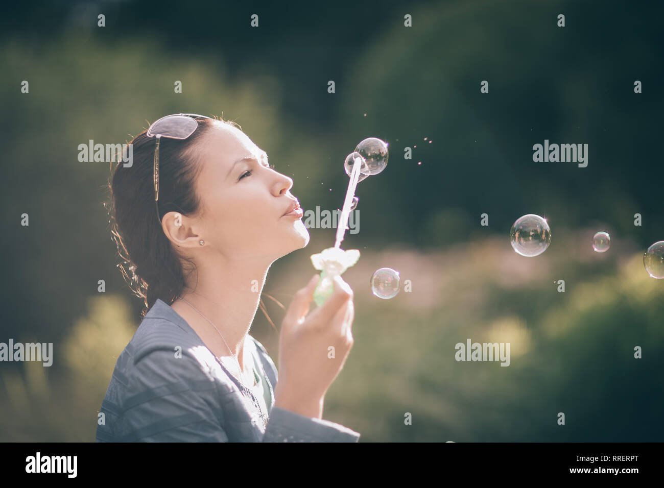 close up. beautiful young woman blowing bubbles Stock Photo - Alamy
