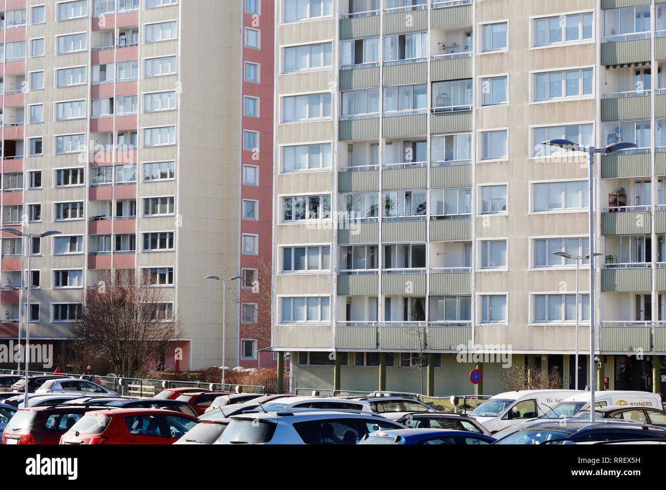 Sodertalje, Sweden - February 24, 2019: Exterior view of multi-family multy-stories apartment buildings 1960s era with parked cars in front in the Bru Stock Photo
