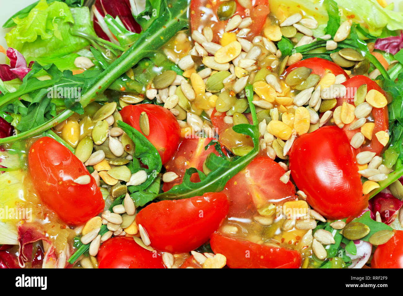 Fresh tomato salad with rocket and seeds Stock Photo Alamy