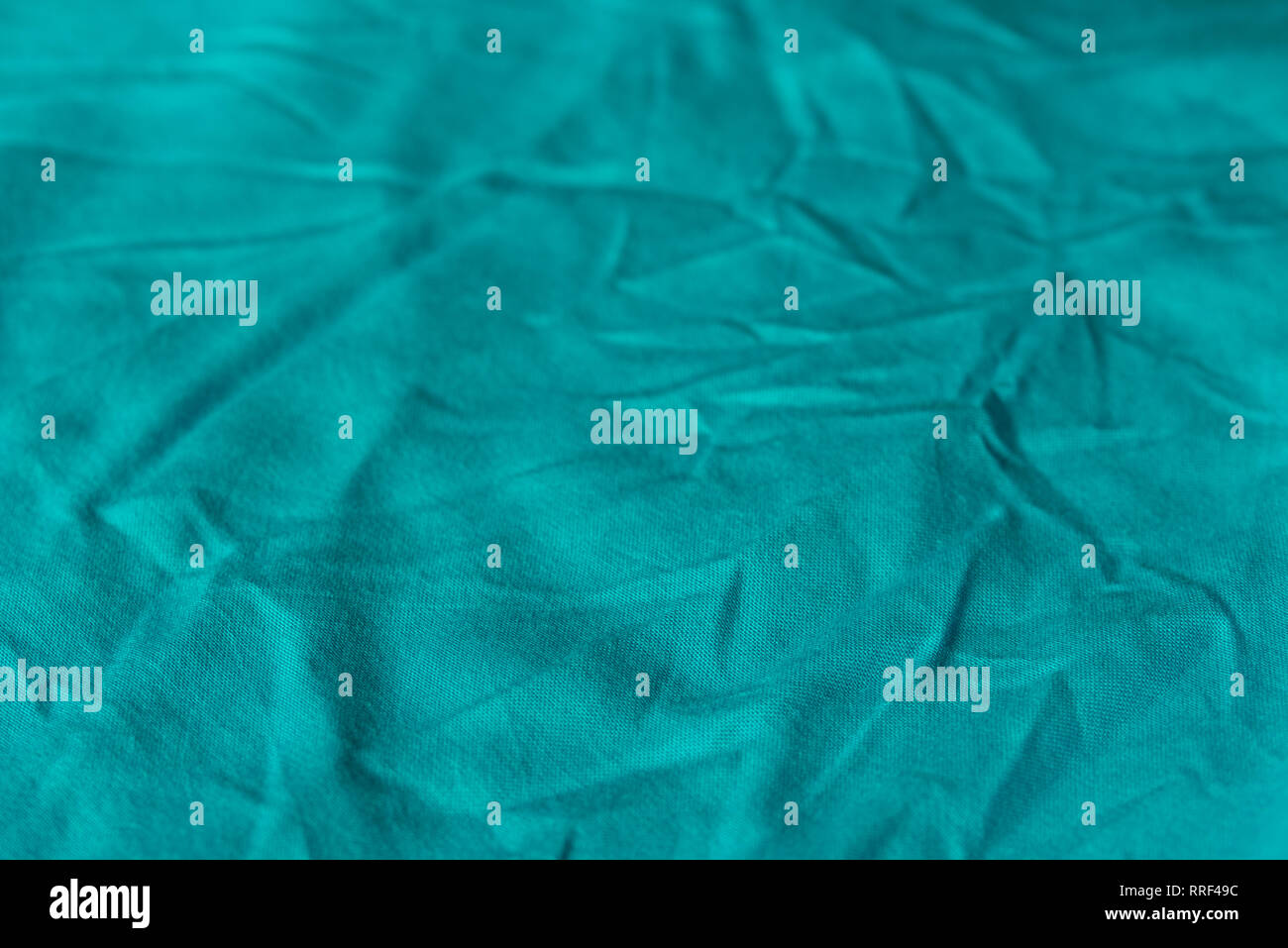 blue color creased textile selective focus background Stock Photo