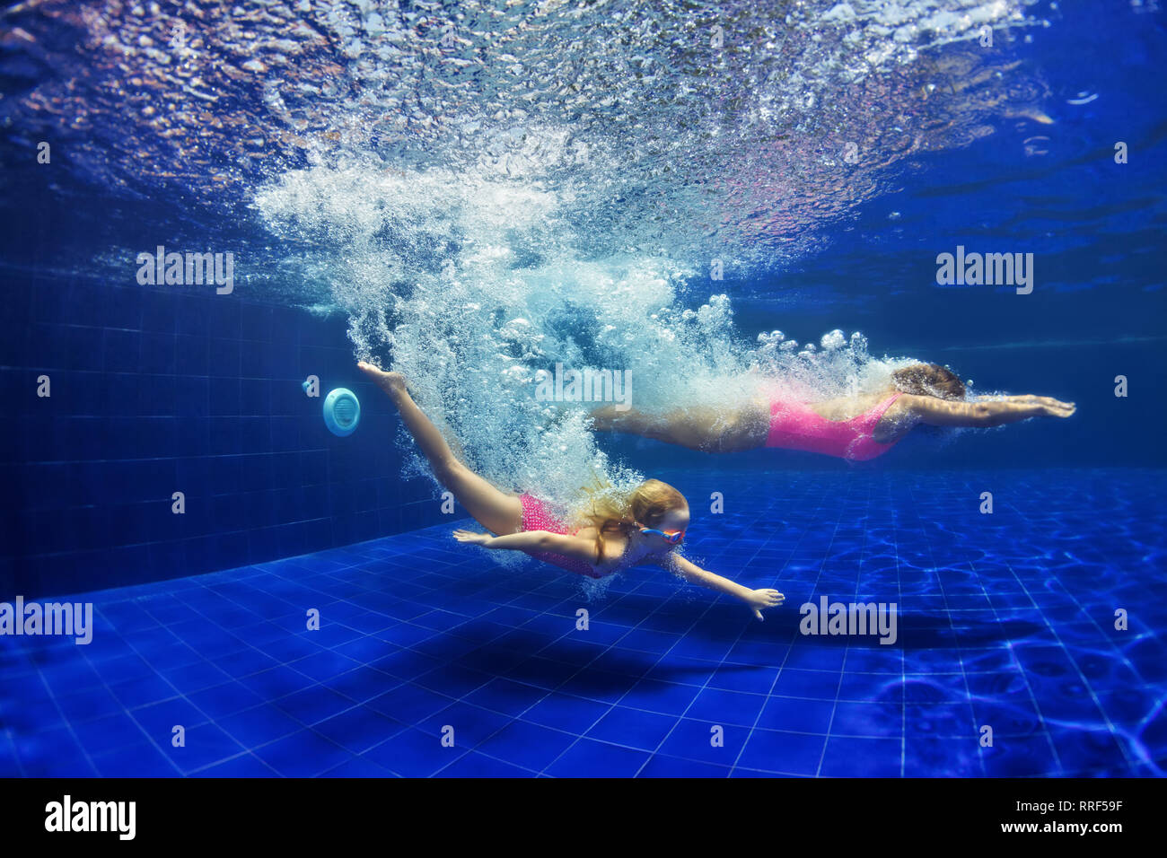 Happy family mother, child learn to swim and dive underwater. Jump