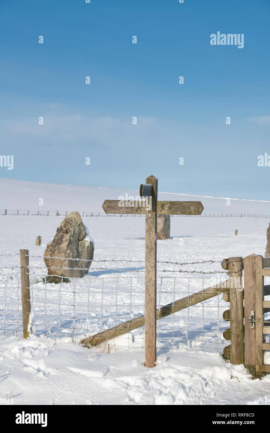 Silbury hill walking signpost in the winter snow just after sunrise. Avebury, Wiltshire, England Stock Photo