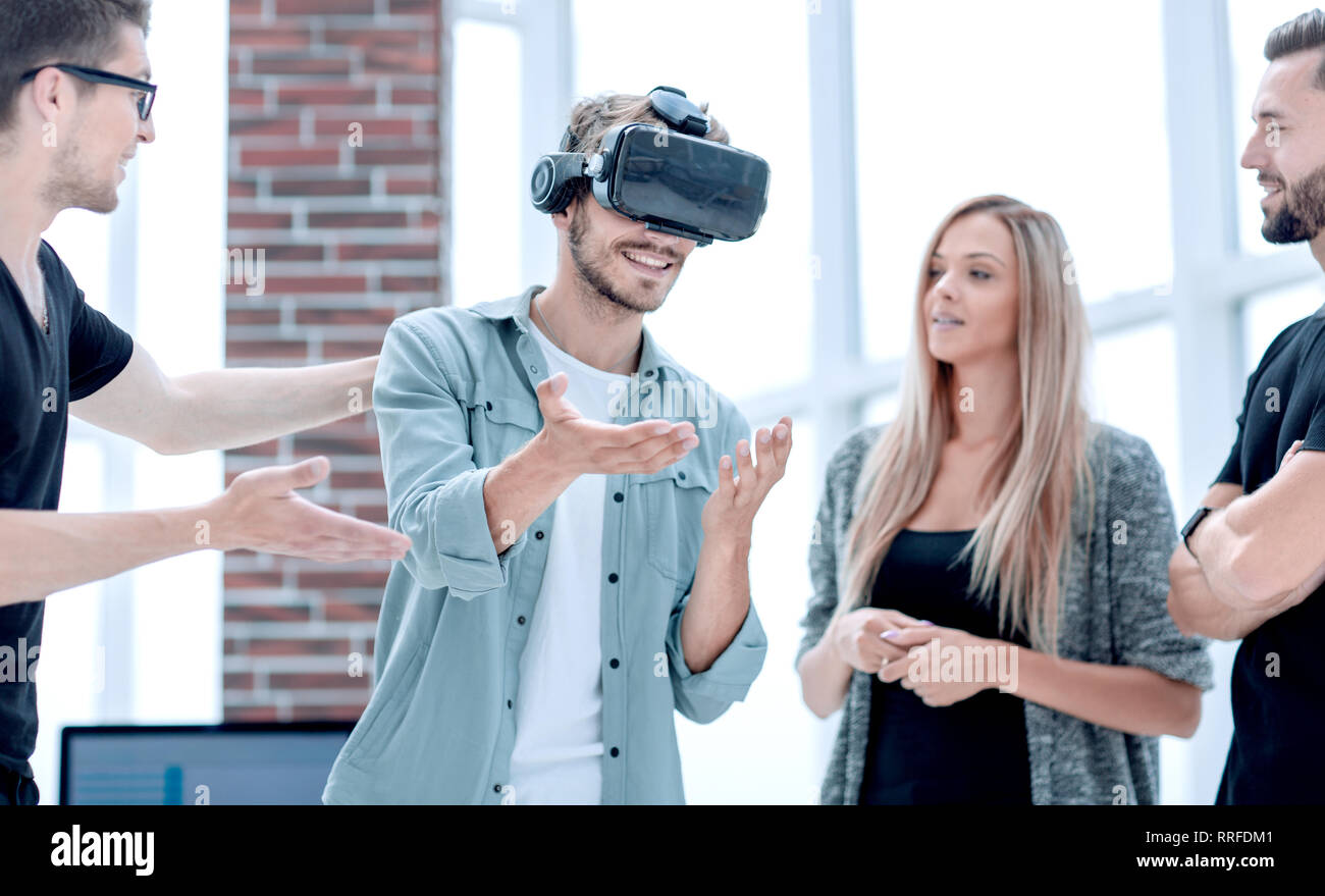 Positive colleagues testing virtual reality glasses Stock Photo