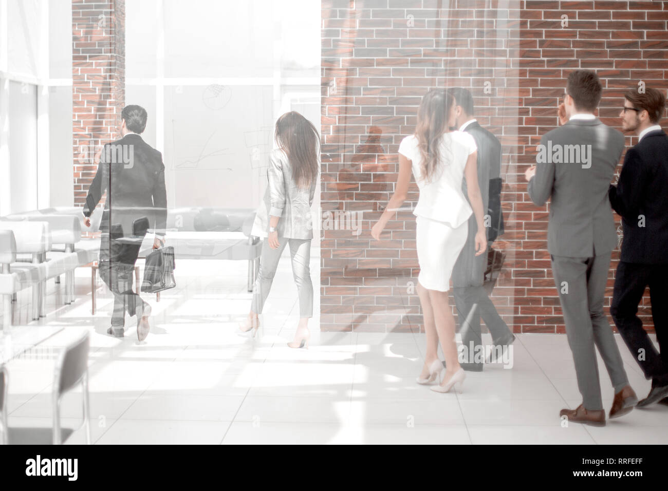 employees walking through the office hall Stock Photo - Alamy