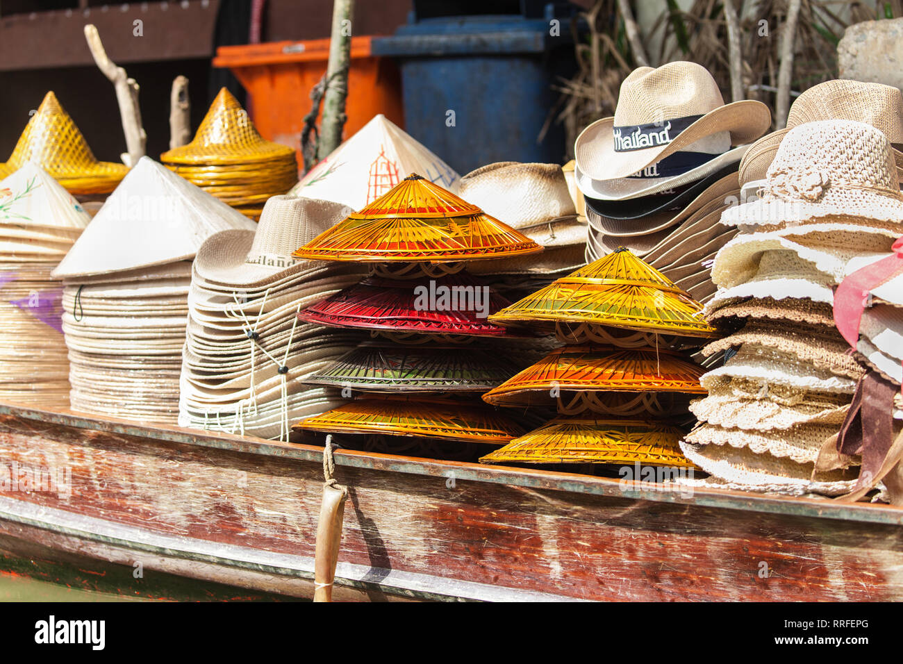 Piles of hats on a wooden boat in Damnoen Saduak Floating Market, Ratchaburi, Thailand. Stock Photo