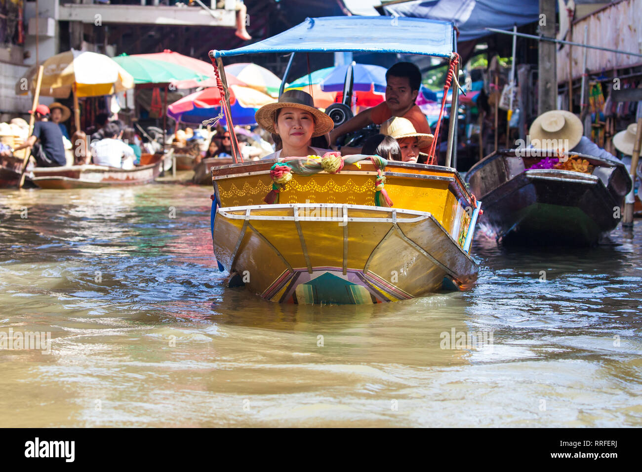 Damnoen Saduak, Thailand - August 29, 2018: Tourists on a Boat in Damnoen Saduak Floating Market, Ratchaburi, Thailand. Stock Photo