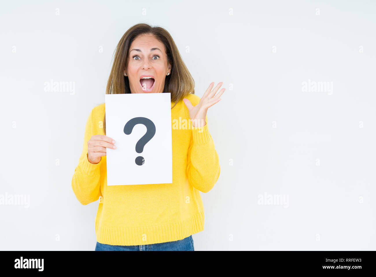 Middle age woman thinking and holding paper with question mark symbol ...