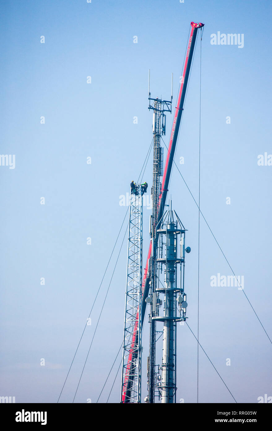 Goats Cross, Crosshaven, Cork, Ireland. 26th February, 2019. Telecom engineers aloft a new communication mast  for 5G technology, being installed at Goat's Cross, Crosshaven, Co. Cork, Ireland. Credit: David Creedon/Alamy Live News Stock Photo