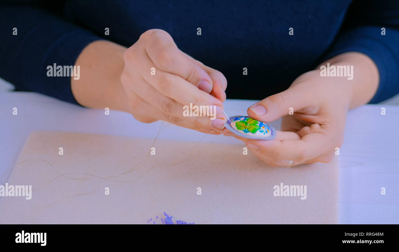 Designer making handmade brooch Stock Photo