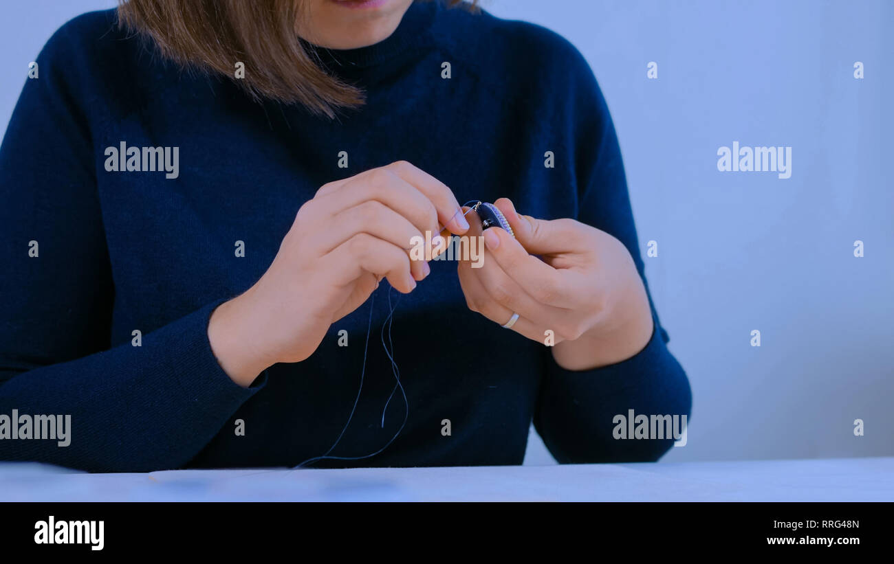 Designer making handmade brooch Stock Photo