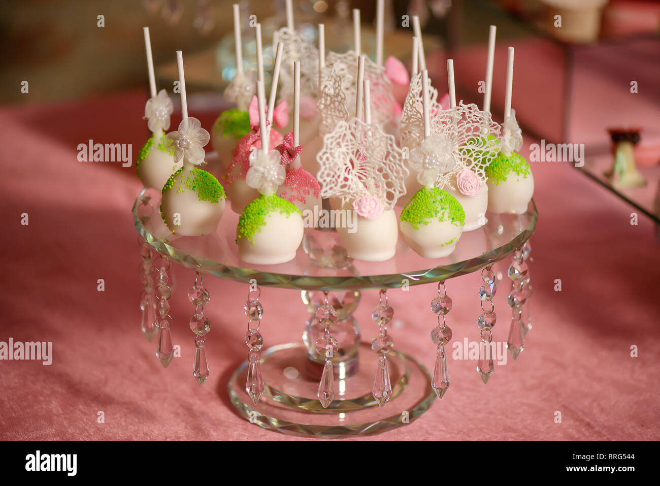 Embellished crystal cake stand exhibiting a generous assortment of colorful  bite-sized bonbon or cake pops with sprinkles, delicious dessert variety  Stock Photo - Alamy