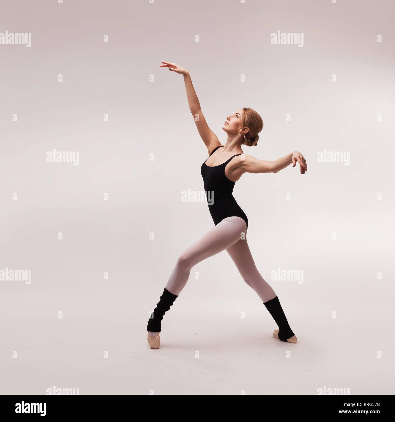 Ballerina in black outfit posing on toes Stock Photo