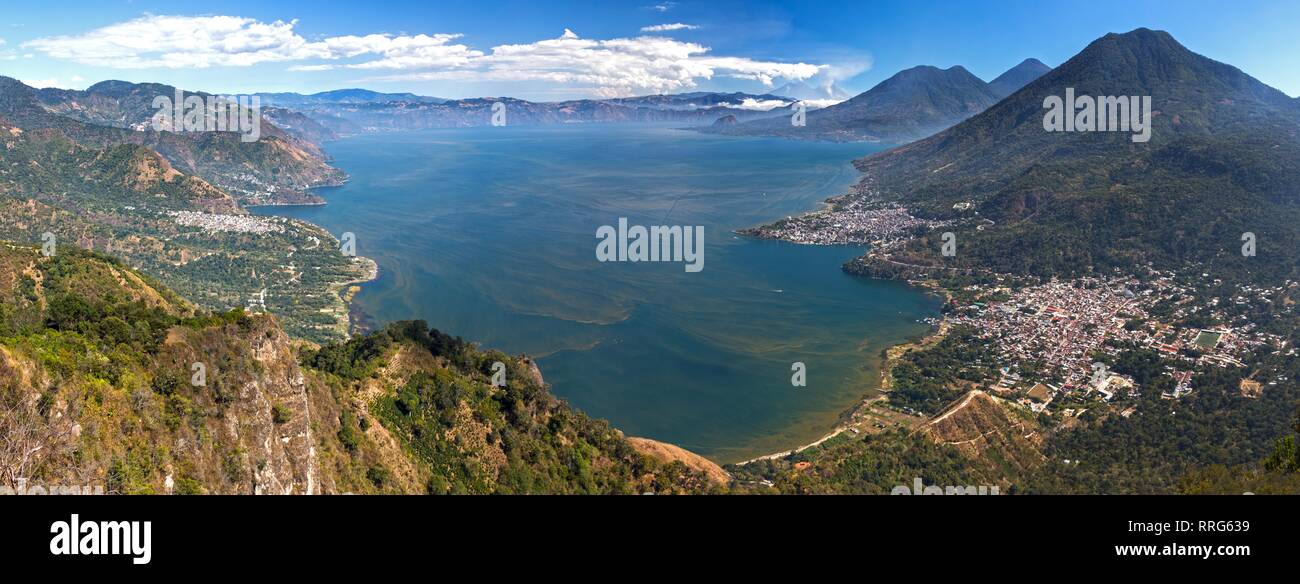 Wide Panoramic Aerial Landscape View of Beautiful Blue Lake Atitlan in Guatemala. Volcanoes, Panajachel and San Pedro Villages on Horizon Stock Photo