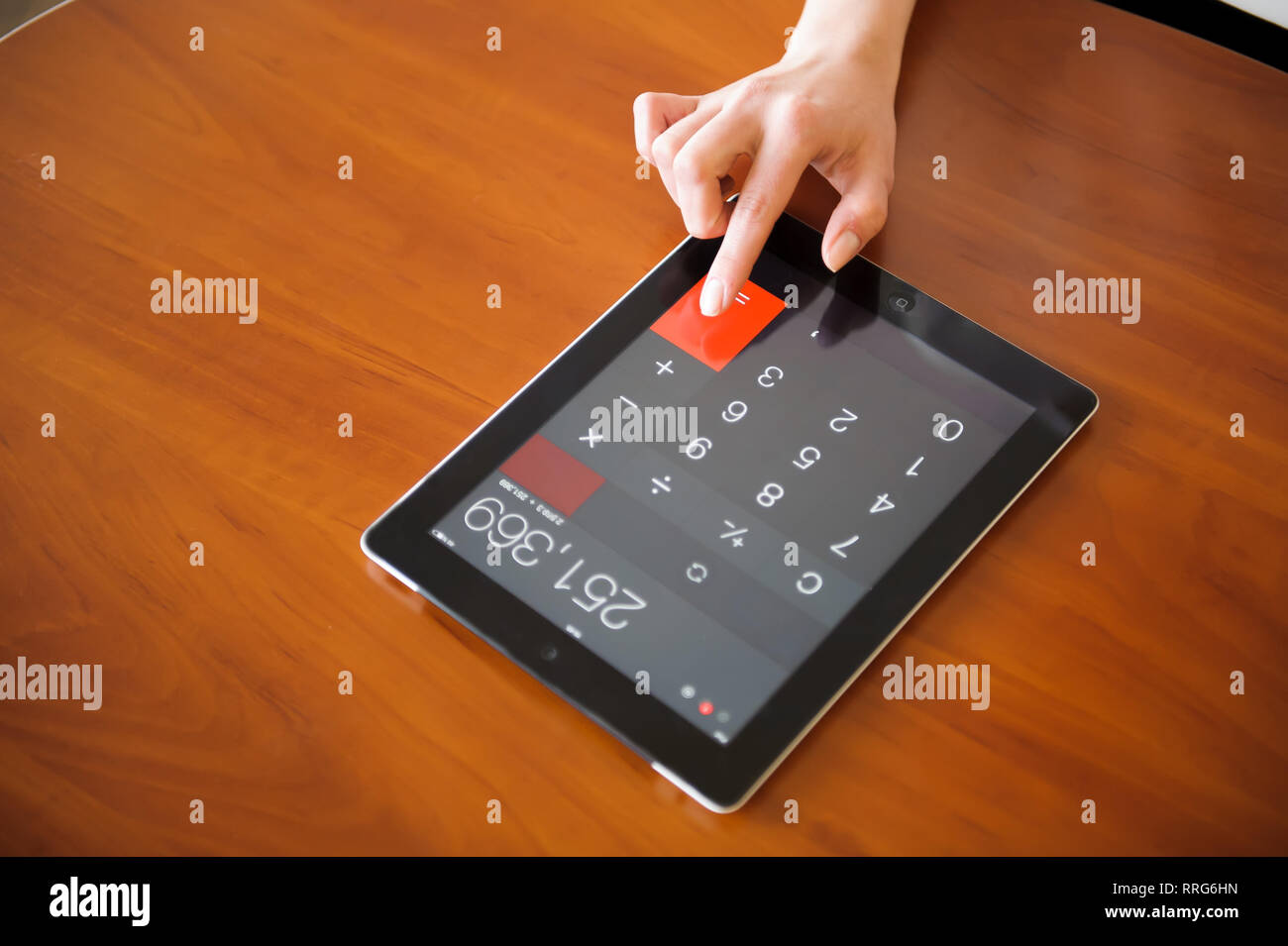 Human Hand and Digital Tablet. calculator bill Stock Photo