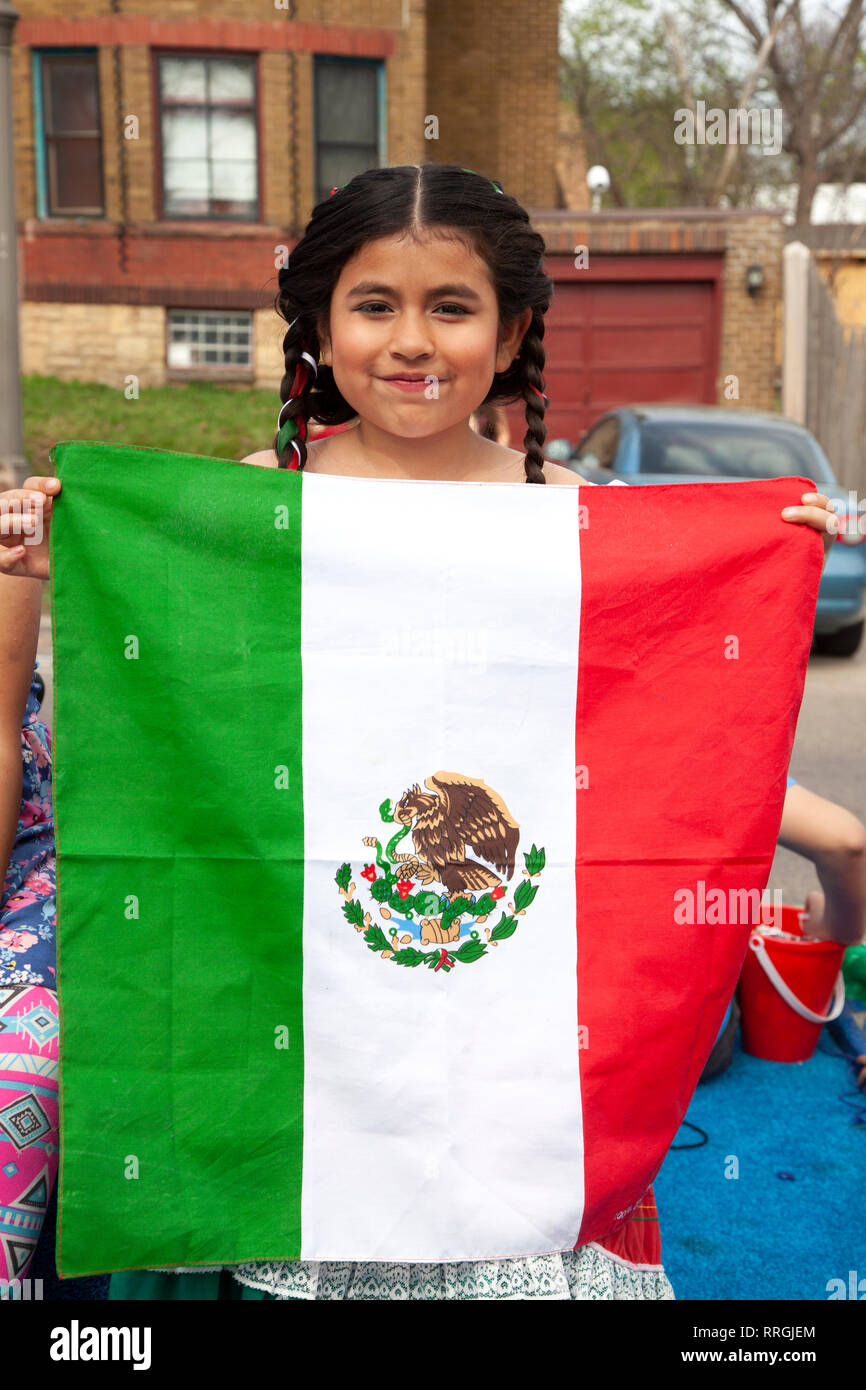Hispanic teen holding the Mexican flag at the Cinco de Mayo Parade. St Paul Minnesota MN USA Stock Photo