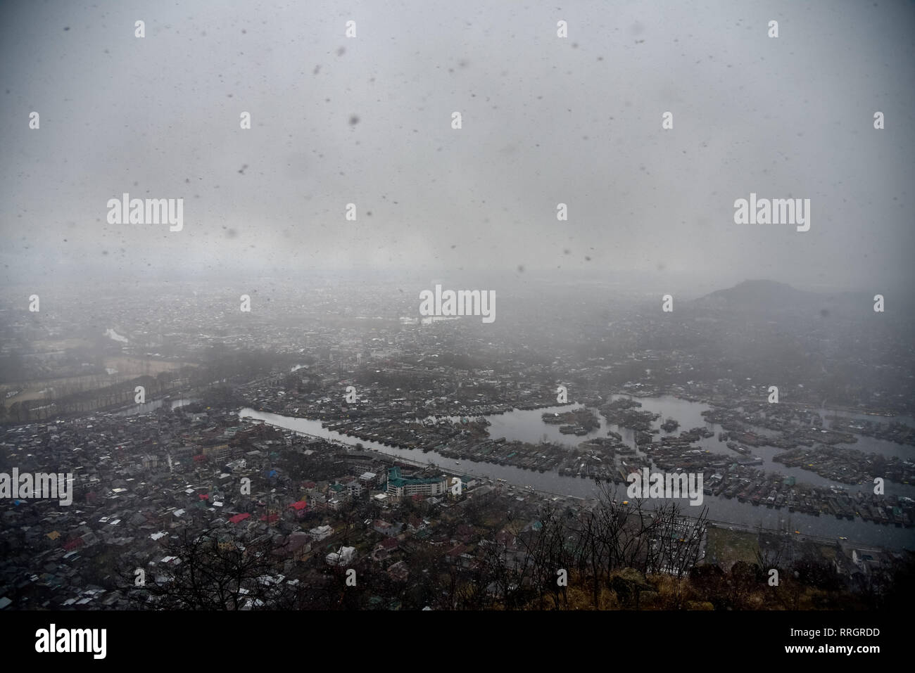 An aerial view of Srinagar city from Shankar Acharya hill amid fresh snowfall. Kashmir has been divided between India and Pakistan since their partition and independence from Britain in 1947. The disputed region is claimed in full by both sides, which have fought three wars over it. Stock Photo