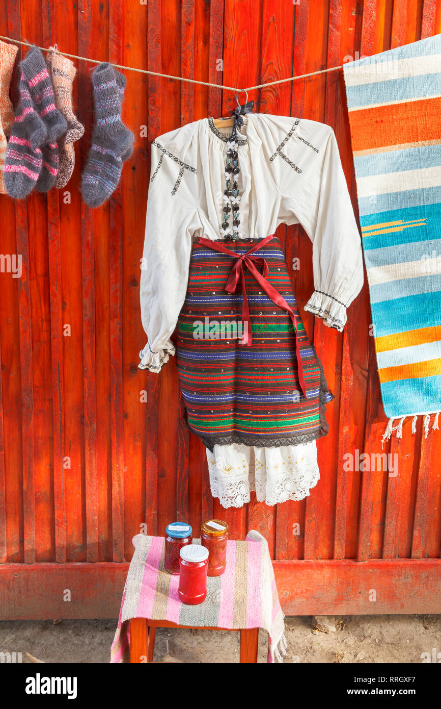 Local style clothes and produce hung up on display for sale on the roadside in the Saxon Village of Viscry, Brasov region, Transylvania, Romania Stock Photo