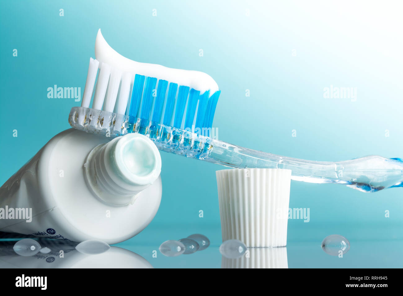 New toothbrush with toothpaste closeup in the bathroom on a mirror