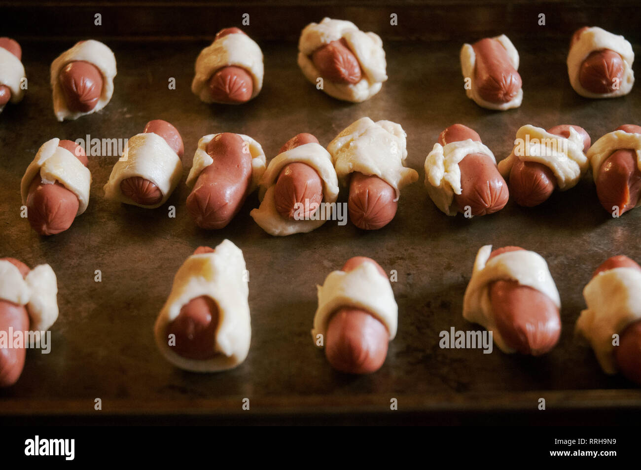 PigsinaBlanket Miniature Hot Dogs Wrapped in Pastry Dough on Baking Sheet Stock Photo Alamy