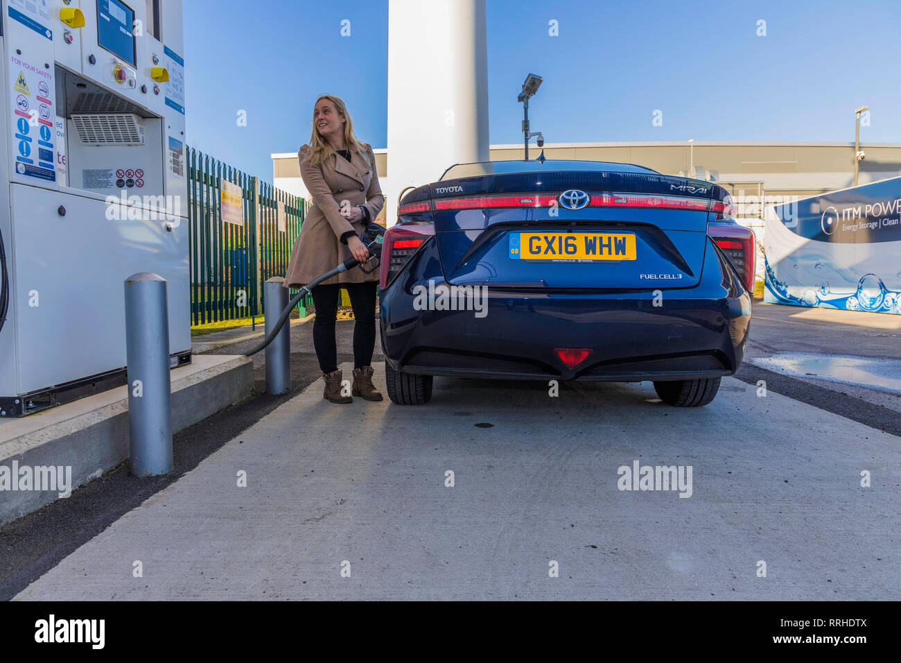 Woman refuelling a hydrogen car Stock Photo