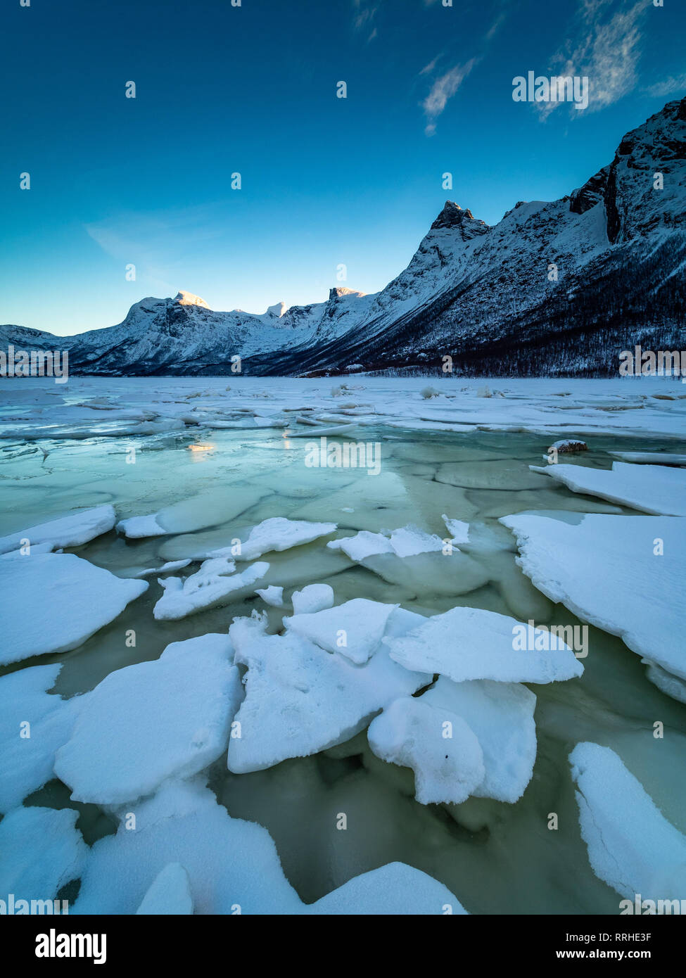 Ice Braking Up On A Frozen Lake With Mountains In The Background On The Peninsula Of Kjerringoy In Northern Norway Stock Photo Alamy