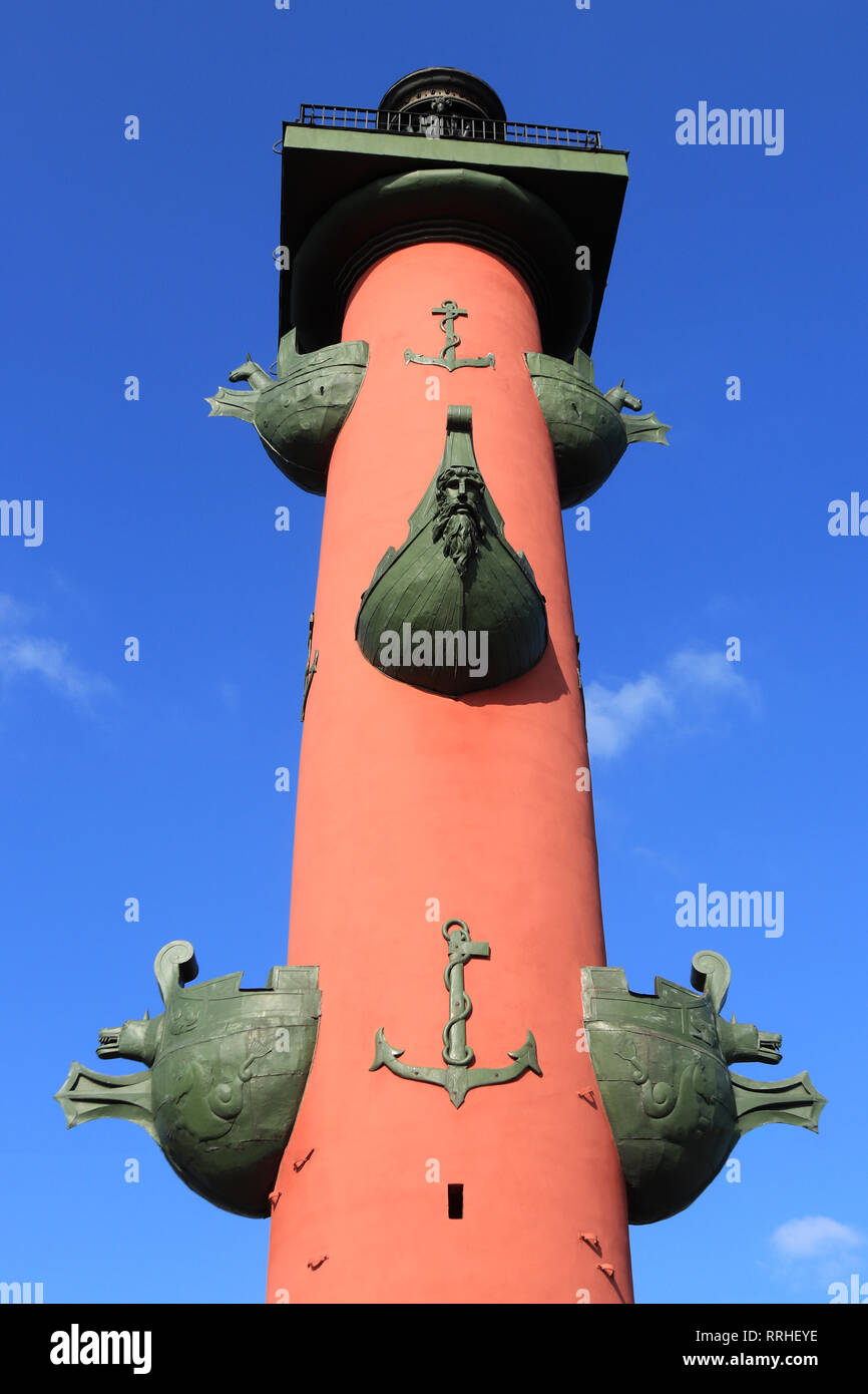 Rostral column. St. Petersburg. A large red column framed by the anchors and figures of the boat's noses. Stock Photo