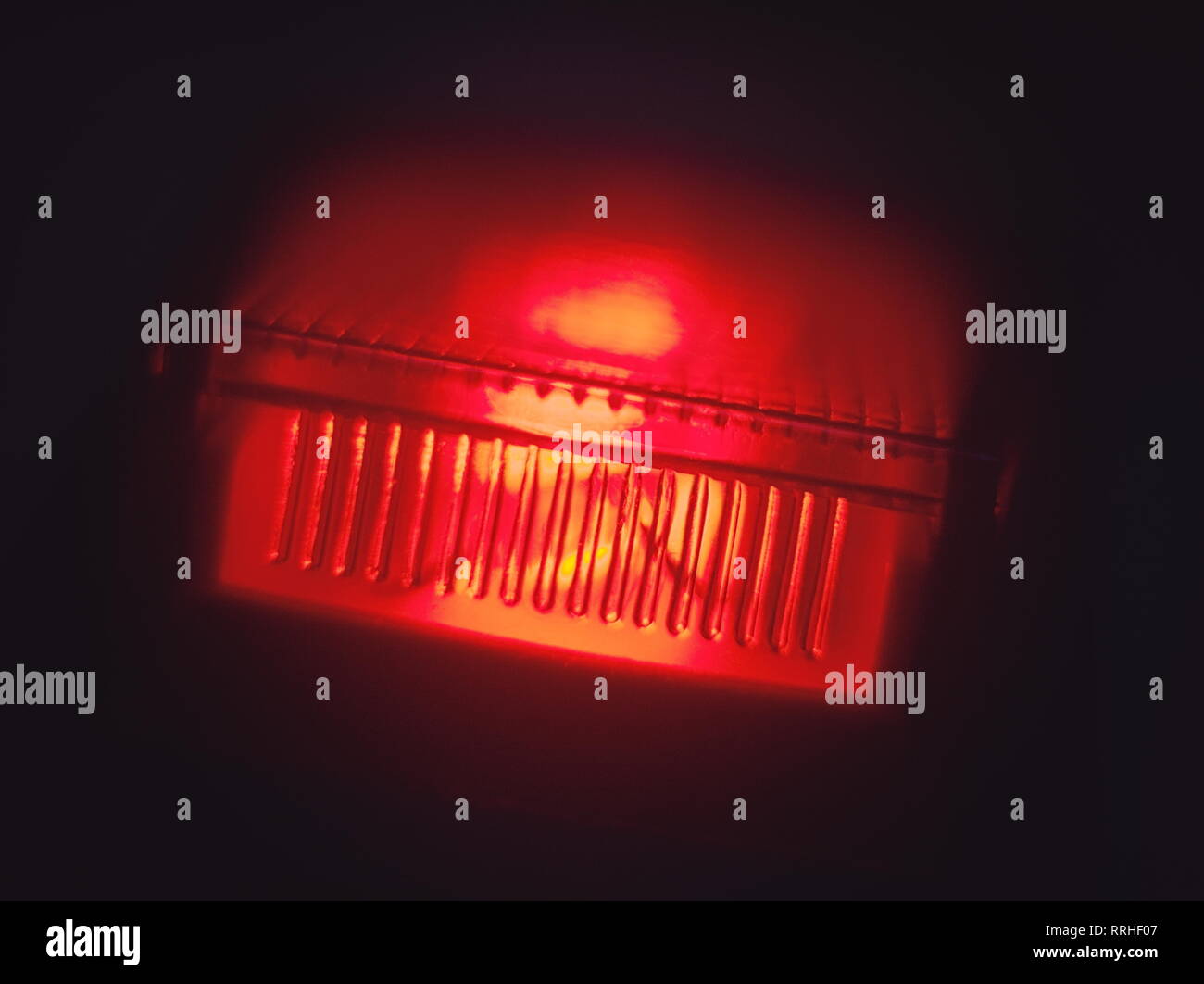 Glowing Red Power Switch in the Dark Macro Closeup Stock Photo