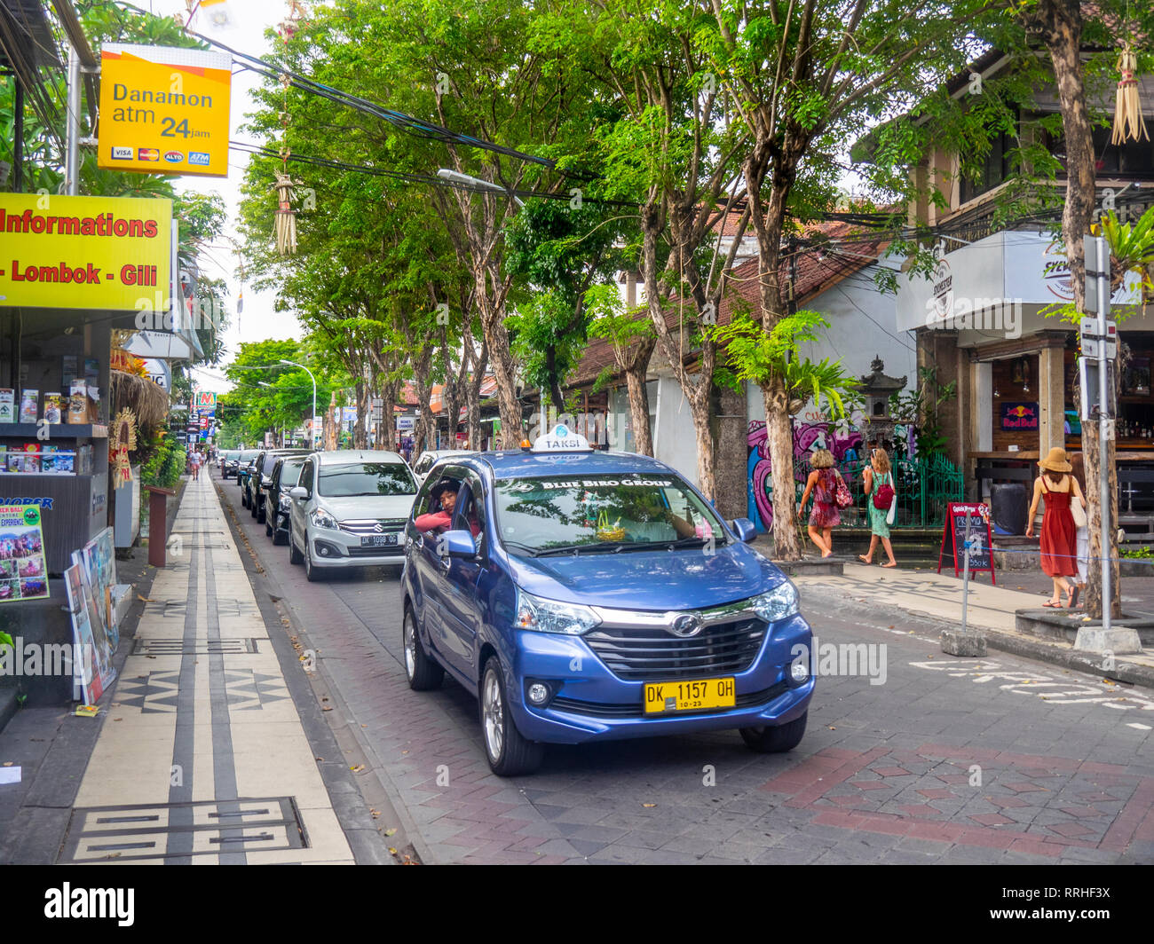 Bluebird taxi and local traffic in busy Jl Raya Legian in Kuta Bali Indonesia. Stock Photo