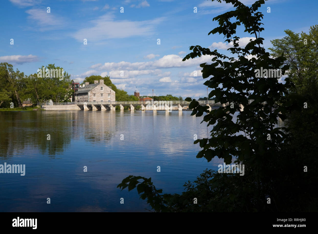 The Des Mille-Iles River and the New Mill on Ile des Moulins Historic Site in spring, Old Terrebonne, Lanaudiere, Quebec, Canada Stock Photo