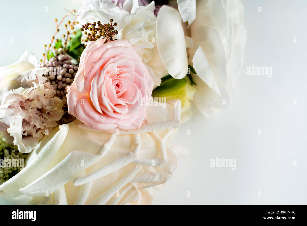 Bouquet of white roses lying on the white table.  Stock Photo