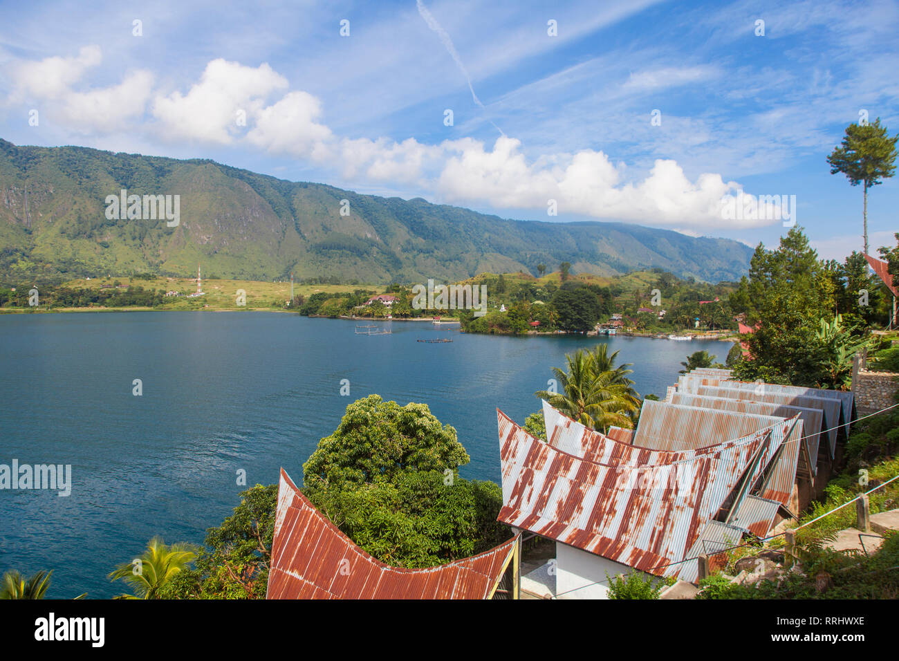 Typical Batak houses overlooking Lake Toba, Tuk Tuk, Lake Toba, Samosir Island, Sumatra, Indonesia, Southeast Asia, Asia Stock Photo